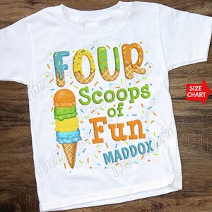May include: White t-shirt with a colourful ice cream cone graphic and the text "Four Scoops of Fun Maddox".