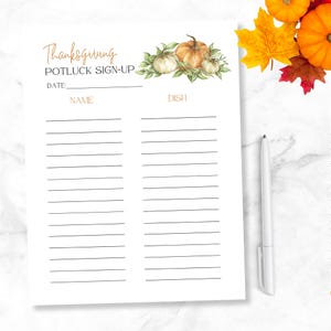 May include: Printable Thanksgiving potluck sign-up sheet with a watercolor illustration of pumpkins and fall leaves. The sheet has a space for the date, name, and dish.