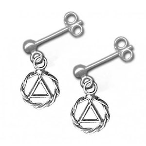 May include: A pair of silver earrings with a small circle pendant featuring a triangle inside. The triangle is surrounded by a braided rope design.
