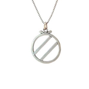 May include: A silver necklace with a round pendant featuring a striped design. The pendant is shaped like a circle with two parallel lines inside.