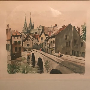May include: A watercolor painting of a European village with a bridge over a river. The buildings are in shades of gray and brown, with a church in the background. The bridge is made of stone and has several arches. The river is a light blue color.
