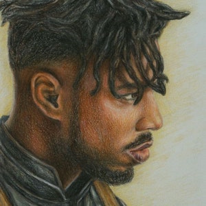 May include: A colored pencil portrait of a man in profile, featuring a detailed depiction of his face and hair. The artwork showcases a dark complexion, short dark hair, and a neatly trimmed beard. The man is wearing a dark jacket with gold accents. The artist's signature and the year 2018 are visible.