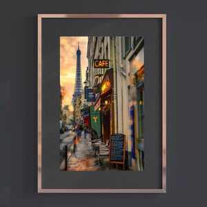 May include: A framed photograph of a Parisian street scene with a cafe and the Eiffel Tower in the background. The cafe has a sign that reads "CAFE" in yellow letters. There are tables and chairs set up outside the cafe.