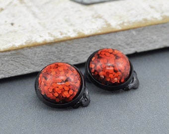 Earclips "Juleglimmer" earrings with red glitter Cabochon edged in black