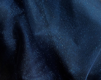 May include: A close-up of a dark blue sheer fabric with a subtle sparkle. The fabric is wrinkled and has a soft, flowing texture.