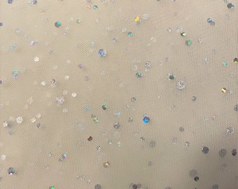 May include: White tulle fabric with iridescent sequins scattered throughout. The sequins are various sizes and shapes.