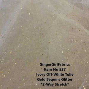 May include: Ivory off-white tulle fabric with gold sequin glitter. The fabric has a two-way stretch. GingerGirlFabrics Item No 527.