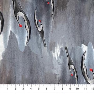 May include: Close-up of a fabric with a watercolor design. The pattern features black, white, and red abstract shapes against a gray and blue background. A ruler is at the bottom, showing measurements in inches.