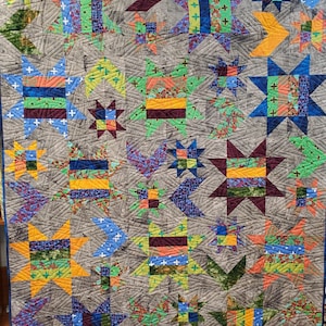 Frond Design Studios  Super Star with Medusa quilt kit    Size = 64″ x 80″  Sold by the kit