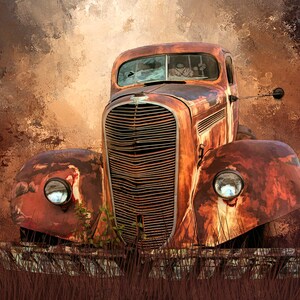 May include: A rusty, vintage truck with a weathered appearance. The vehicle's front features a prominent grille, round headlights, and a cracked windshield. The truck is set against a textured, brown background, with tall grass in the foreground.