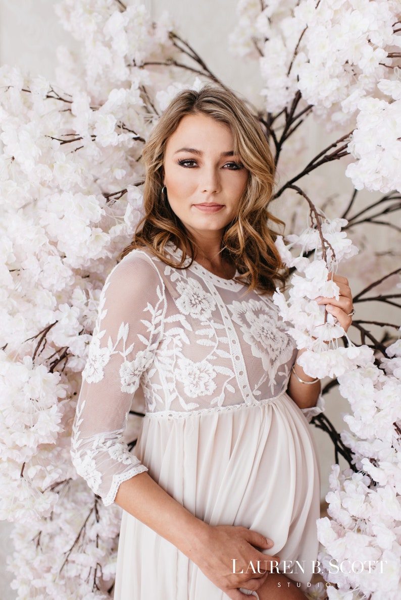 Karina is the boho lace maternity dress of your dreams. With a sheer bust and chiffon skirt, this maternity gown is a beautiful option for your maternity shoot or special event. Crochet lace and long sleeves add interest to the gorgeous look.