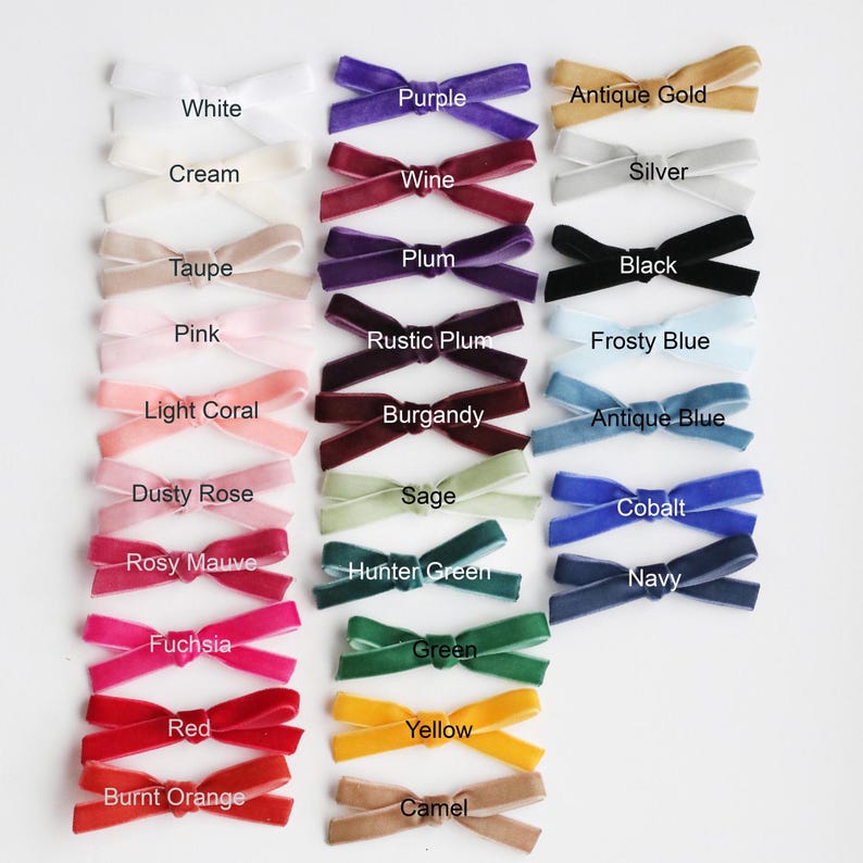 May include: A color chart of 20 velvet ribbon bows, each tied in a simple bow shape. The colors include white, cream, taupe, pink, light coral, dusty rose, rosy mauve, fuchsia, red, burnt orange, purple, wine, plum, rustic plum, burgundy, sage, hunter green, green, yellow, and camel.
