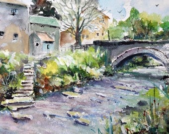 May include: Watercolor painting of a quaint village scene. A stone bridge arches over a flowing river, with buildings and lush greenery on either side. The artwork captures a serene landscape with soft colors and a sense of tranquility.