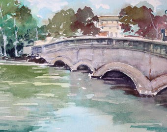 May include: Watercolor painting of a stone bridge with multiple arches over a body of water. Trees and a building are in the background. The water reflects the bridge and sky. The painting is signed in the lower right corner.