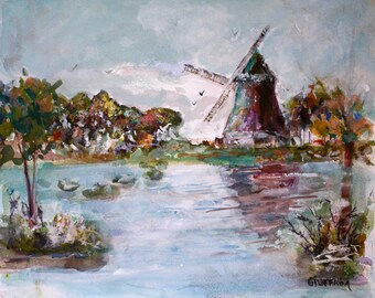 May include: A watercolor painting depicting a windmill standing near a body of water with trees and foliage in the background. The sky is light blue with soft clouds, and the artist's signature, Giuffrida, is visible in the bottom right corner.