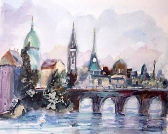 May include: Watercolor painting of a European cityscape with a bridge over water. The painting features buildings with domes and spires in shades of green, brown, and purple. The sky is a soft blend of white and lavender.