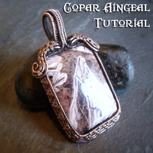 May include: A copper wire wrapped pendant featuring a rectangular stone with a white and brown pattern. The pendant has a loop at the top for attaching to a chain. The text "COPAR ÁINGÉAL TUTORIAL" is visible in the background.