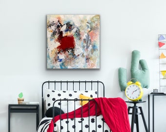 May include: A black metal bed frame with a white and black polka dot duvet cover and a red blanket. A yellow alarm clock sits on a black side table next to a green cactus.