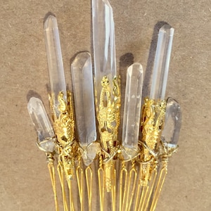 May include: Gold hair comb with clear quartz crystals attached. The crystals are set in gold filigree.