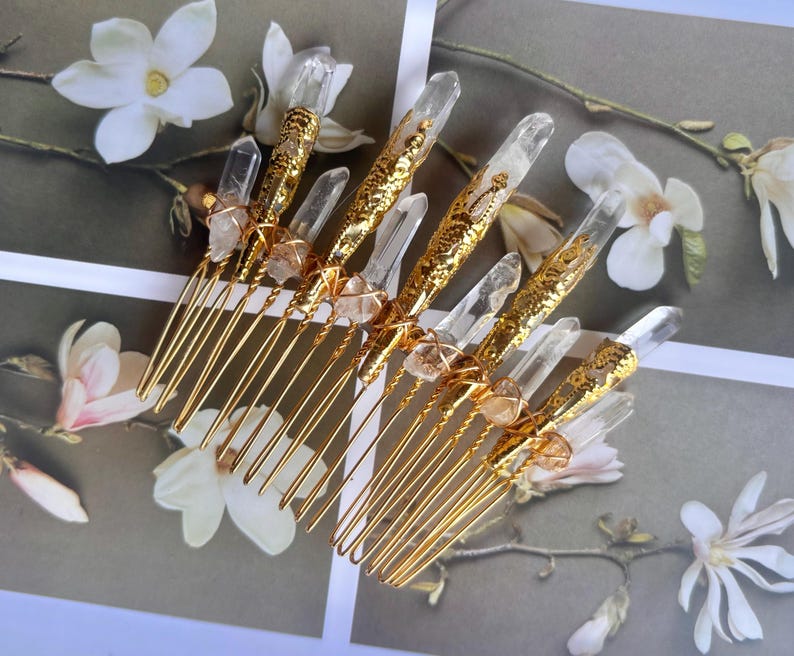 May include: Gold-toned hair combs adorned with clear quartz crystals and decorative gold accents. The combs feature multiple tines and are embellished with natural crystal formations, ideal for bridal or special occasion hairstyles.