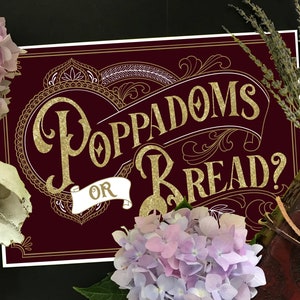 May include: A burgundy sign with gold lettering that reads "Poppadoms or Bread?" with ornate gold designs around the text. The sign is surrounded by flowers and a book.