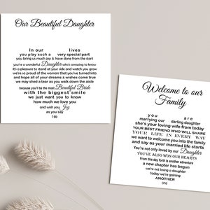 May include: Two white cards with black text. One card reads "Our Beautiful Daughter" with a heart-shaped poem. The other card says "Welcome to our Family" with a heart-shaped poem. Decorative floral elements are in the background.