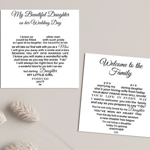 May include: Two white cards with black calligraphy text. One card reads "My Beautiful Daughter on her Wedding Day" with a heart-shaped poem. The other card says "Welcome to the Family" with a heart-shaped poem.