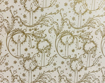 May include: Gold wrapping paper with a repeating pattern of candles and snowflakes. The candles are surrounded by a stylized floral design.