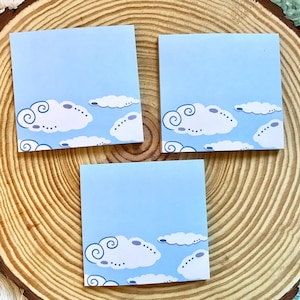 May include: Three blue sticky notes with a white cloud design. Each note features a different arrangement of clouds with swirling details.