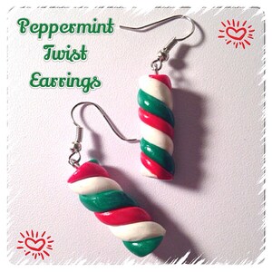 May include: Peppermint Twist Earrings, a pair of silver dangle earrings with red, white, and green candy cane-shaped charms.