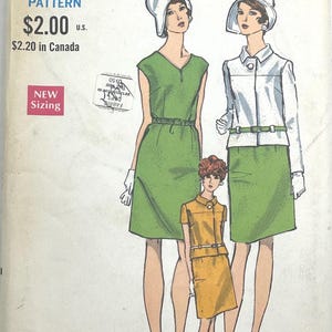 May include: A Vogue sewing pattern envelope featuring illustrations of three outfits: a sleeveless green dress with a belt, a white jacket over a green skirt with a belt, and a mustard yellow short-sleeved dress with a belt. Includes text: VOGUE PATTERN.