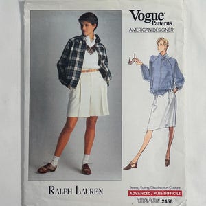 May include: Vogue Patterns sewing pattern featuring Ralph Lauren designs. The pattern includes illustrations of a jacket, shorts, and skirt. The text "AMERICAN DESIGNER" is visible. The pattern is rated "ADVANCED/PLUS DIFFICILE" with pattern number 2456.