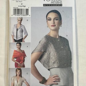 May include: Vogue Patterns accessories pattern V8721. The pattern features images of women wearing different styles of jackets and shawls. The pattern includes the text "ELIZABETH GILLETT NYC".
