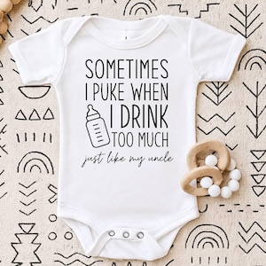 May include: A white short-sleeved baby bodysuit featuring black text that reads: SOMETIMES I PUKE WHEN I DRINK TOO MUCH just like my uncle. The design includes a graphic of a baby bottle. The garment has a round neckline and three metal snaps.