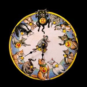 May include: A whimsical clock face with a white background and a black cat at the top. The clock face is surrounded by 12 cats, each holding a piece of cheese. The numbers 12, 9, 6, and 3 are visible on the clock face. A mouse is in the center of the clock face, holding a piece of cheese.