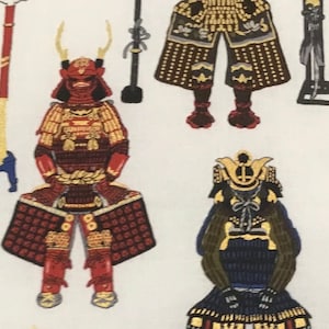 May include: White fabric with a repeating pattern of Japanese samurai armor, weapons, and flags. The armor is detailed with gold, red, and black accents. Various weapons and flags are scattered across the design.