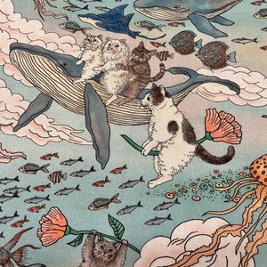 May include: A light blue fabric print featuring a whimsical underwater scene with multiple cats, whales, jellyfish, and various small fish. The cats are depicted interacting with whales and holding orange flowers amidst pink clouds and aquatic life.