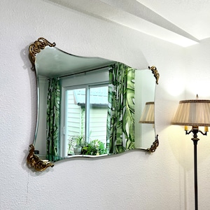 Art Nouveau Frameless Mirror with beveled Serpentine Edges and gold Acanthus Leaf corner fittings 51” x 33”, Vintage 1950s