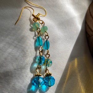 Blue glass dangle earrings on tarnish free gold colored wire