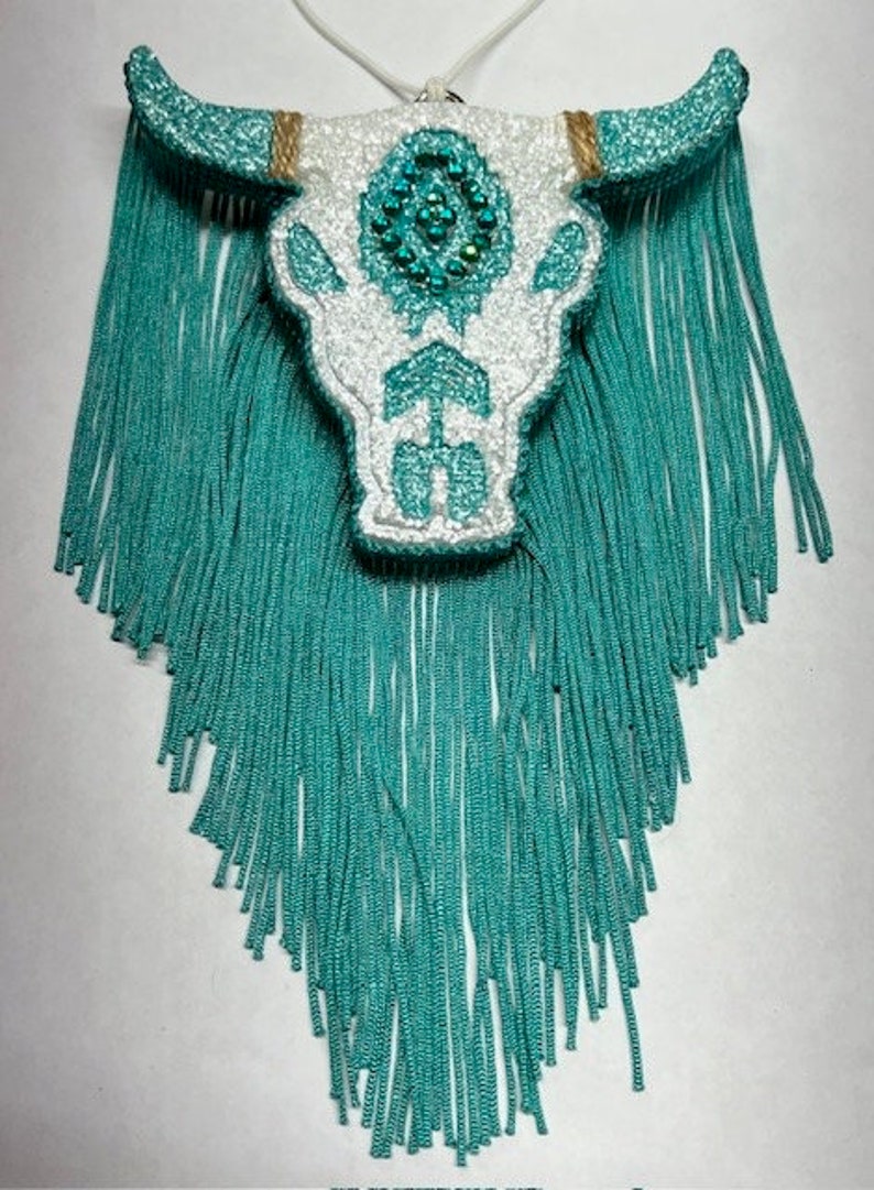 May include: White and turquoise beaded bull skull with turquoise fringe.