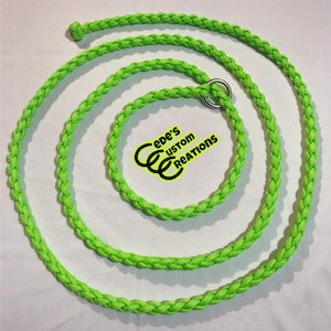 May include: A bright green braided rope leash with a silver metal ring. The rope is coiled in a circle and the ring is attached to the end of the rope. The text "Cede's Custom Creations" is visible in the center of the image.