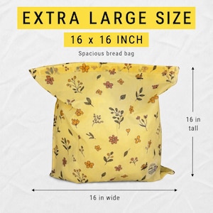 May include: A yellow bread bag featuring a floral pattern with small orange, brown, and green flowers and leaves. The bag is labeled as extra large size, measuring 16 inches wide by 16 inches tall, with the text "EXTRA LARGE SIZE" and "16 x 16 INCH".