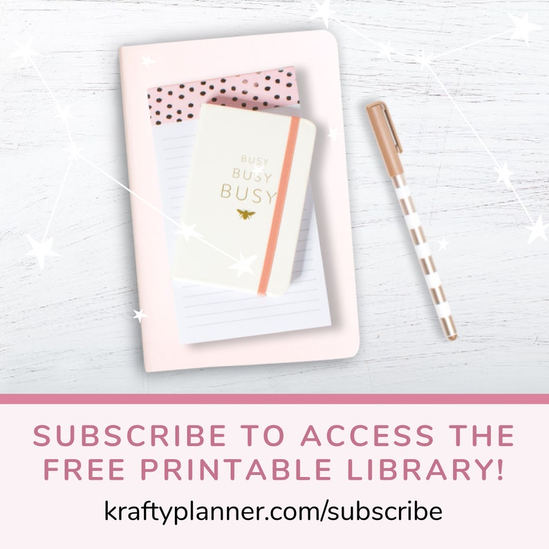 May include: A pink notebook with a white notepad and a smaller white notebook with the text "BUSY BUSY BUSY" and a bee icon. A gold pen with white stripes is on the right side of the image. The background is a white wooden surface with white stars.