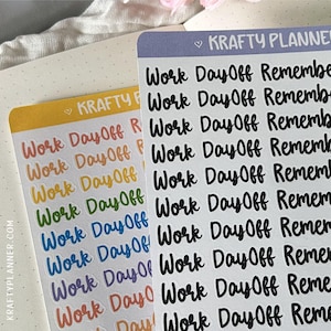 May include: Two sheets of planner stickers with the text "Work Day Off Remember". One sheet has colorful text, the other has black text. The brand name "KRAFTY PLANNER" is visible on the sheets and the website "KRAFTYPLANNER.COM" is printed on the side of one sheet.