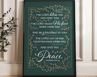May include: A framed print with a dark green background and gold decorative elements. The text reads "The Lord bless you and keep you...and give you Peace. Numbers 6:24-26" in various fonts. The frame is black.