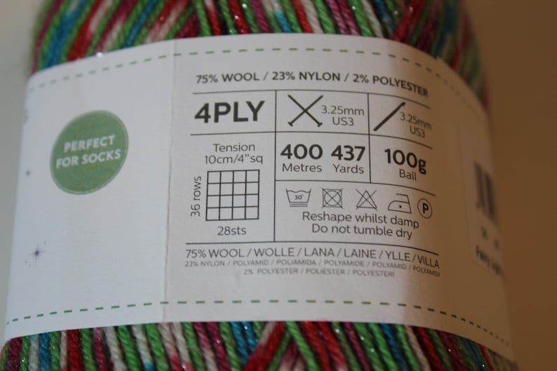 May include: A ball of 4-ply yarn with a label that reads "Perfect for Socks." The yarn is a mix of red, green, blue, and silver. The label includes information about the yarn's composition, weight, and recommended needle size.
