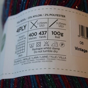 May include: A ball of Vintage Tinsel yarn, 100g, with a label showing knitting instructions and fiber content: 75% wool, 23% nylon, and 2% polyester. The yarn is 4-ply and has 437 yards. The label also includes washing instructions.