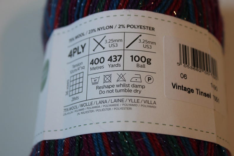 May include: A ball of Vintage Tinsel yarn, 100g, with a label showing knitting instructions and fiber content: 75% wool, 23% nylon, and 2% polyester. The yarn is 4-ply and has 437 yards. The label also includes washing instructions.