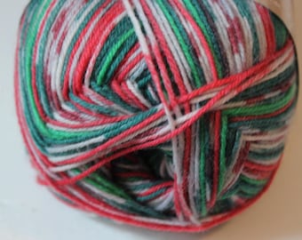 May include: A ball of yarn with a mix of red, green, white, and gray threads. The yarn is tightly wound, showing the different colors intertwined. Ideal for knitting or crocheting projects.