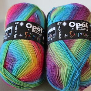May include: Two skeins of Opal Surprise yarn in a rainbow colorway. Each skein is 100g (3.5 oz) and 425m (464 yds) long. The yarn is a blend of wool and polyamide.